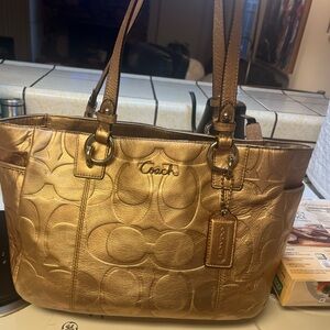 Beautiful gently used gold coach bag .  Shoulder bag  dimensions in photos.